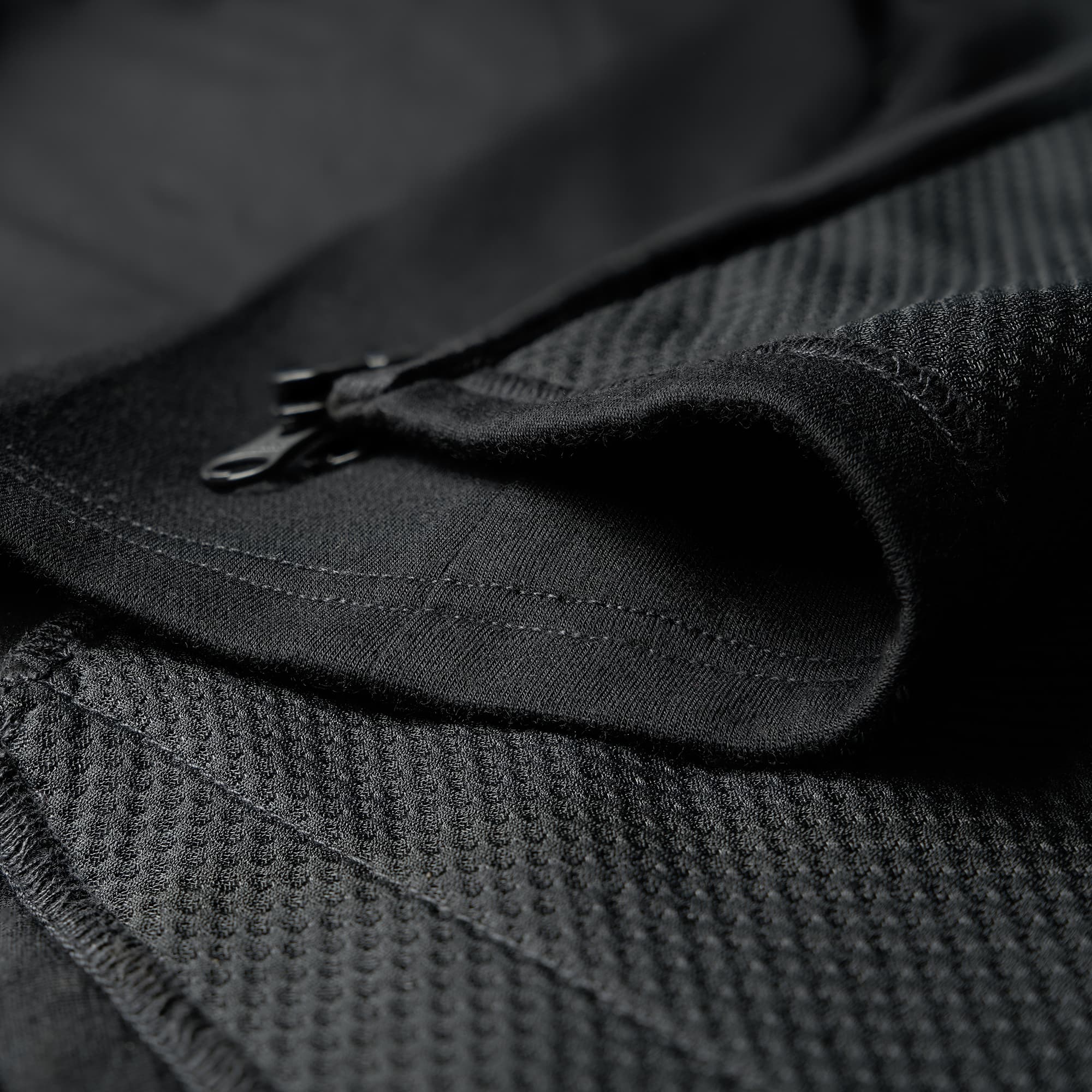 Men's merino blend hoodie in black fabric detail #color_black