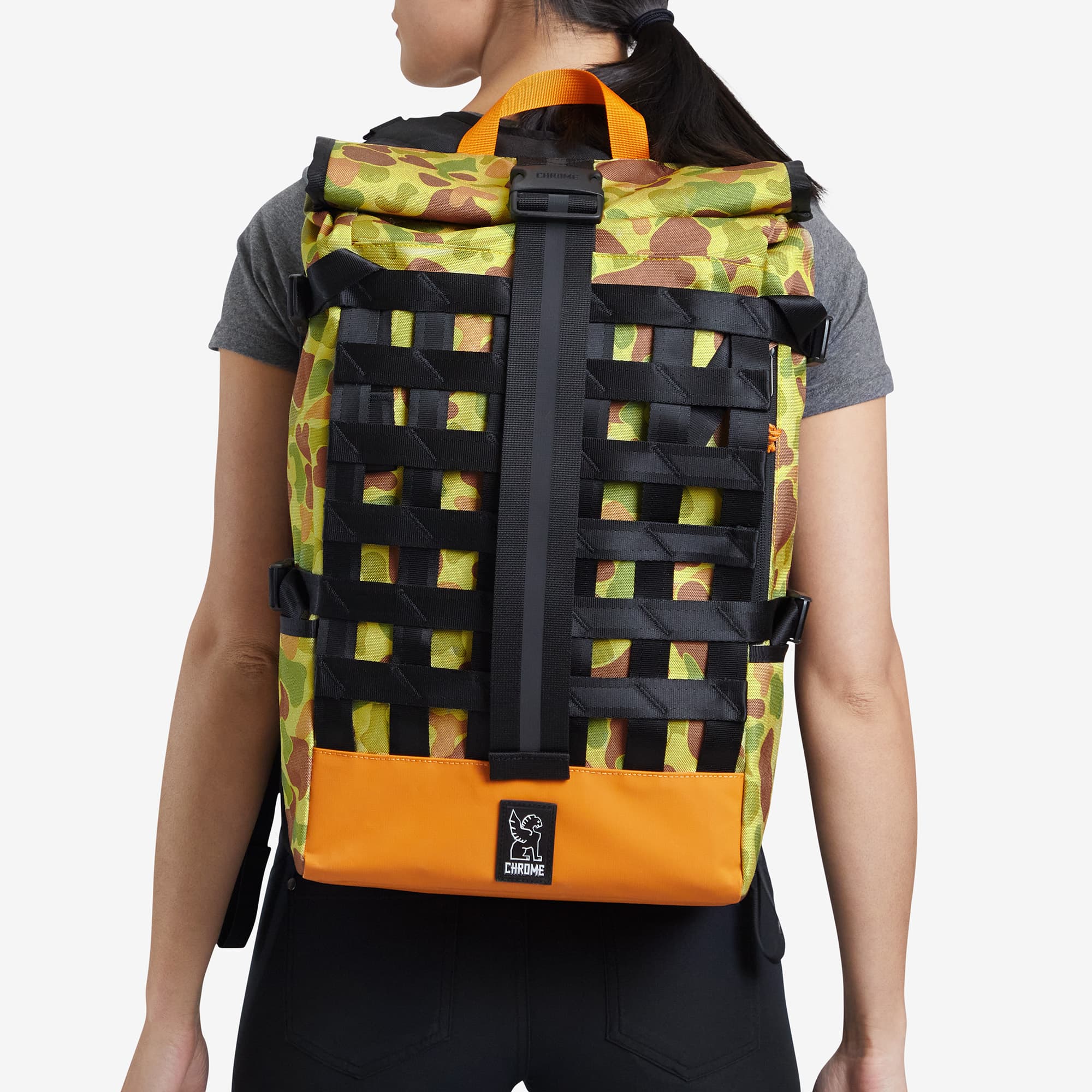 Yellow Camo Barrage Cargo Backpack on a women's back #color_duck camo