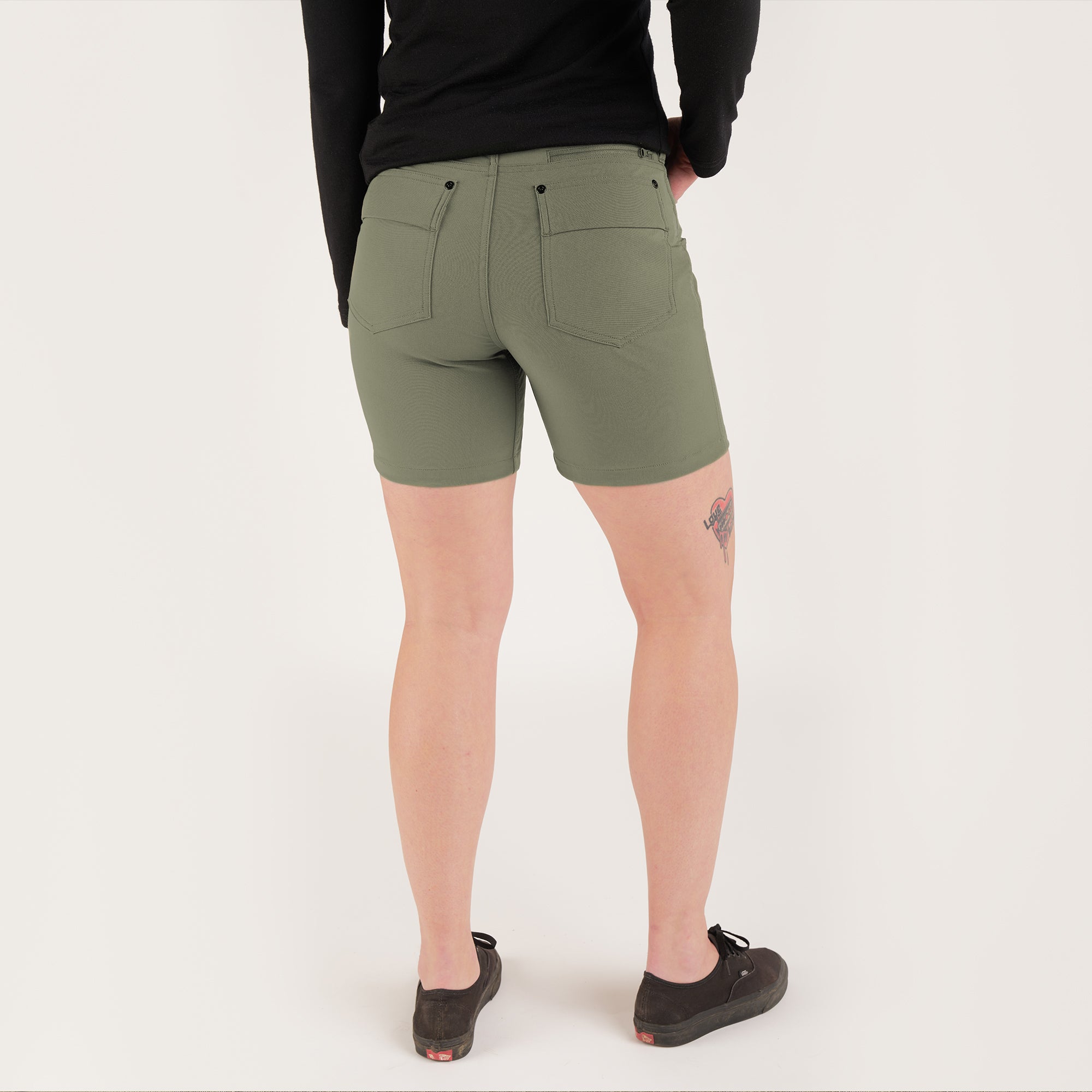 Women's Anza technical short in dusty olive back view on a woman #color_dusty olive
