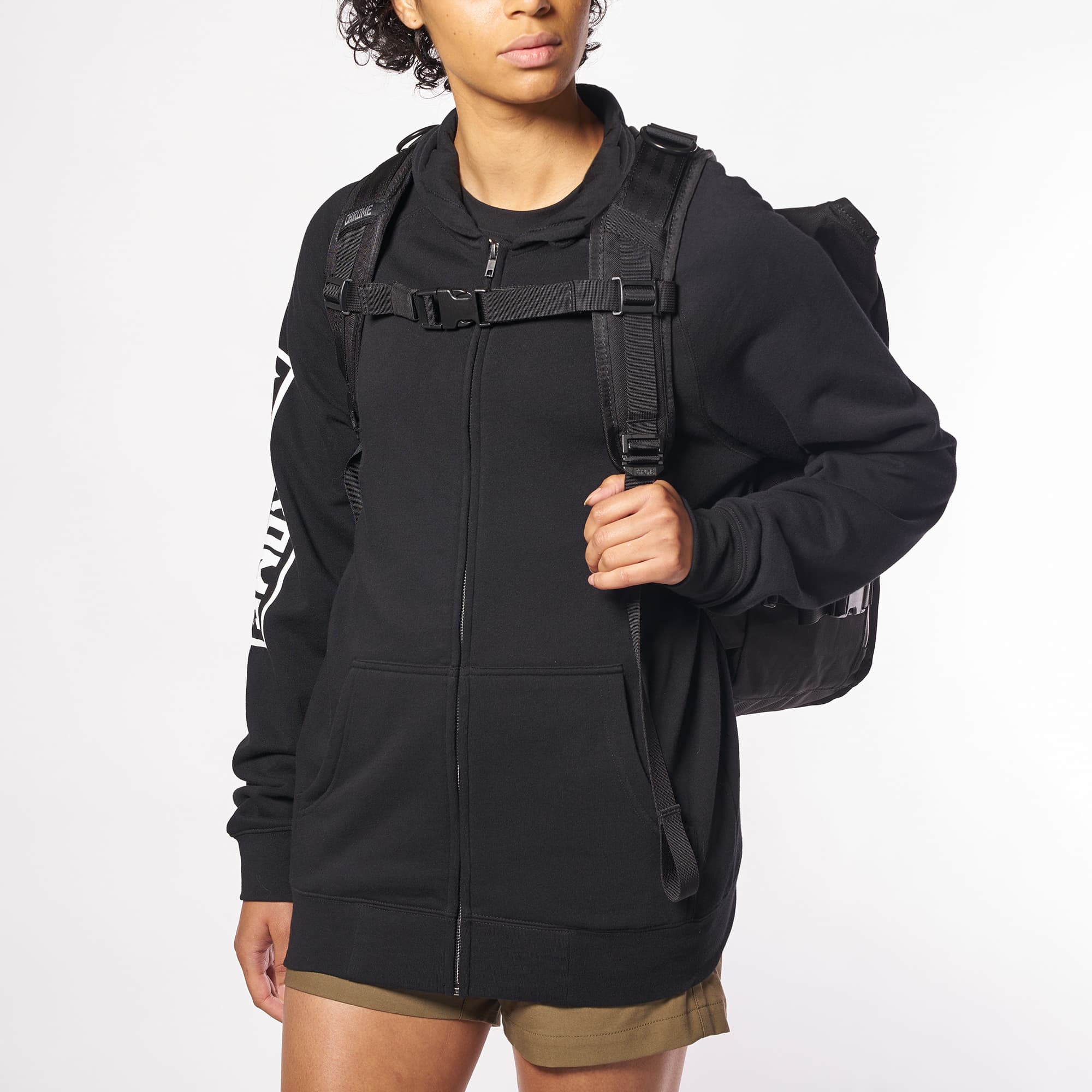 Warsaw medium size flap backpack in black front view worn by a woman