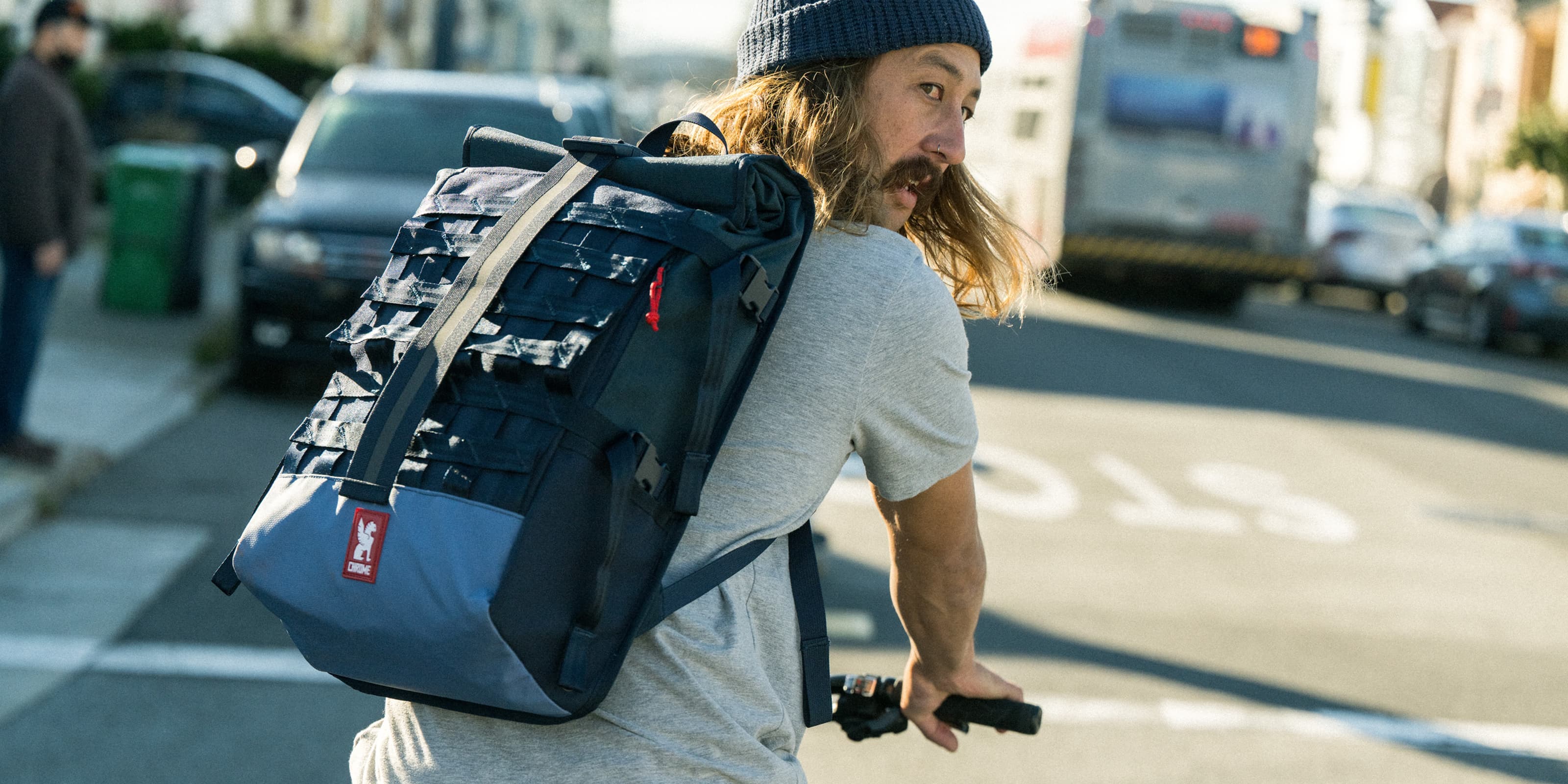 Water-resistant Barrage Cargo Backpack worn by a person cycling