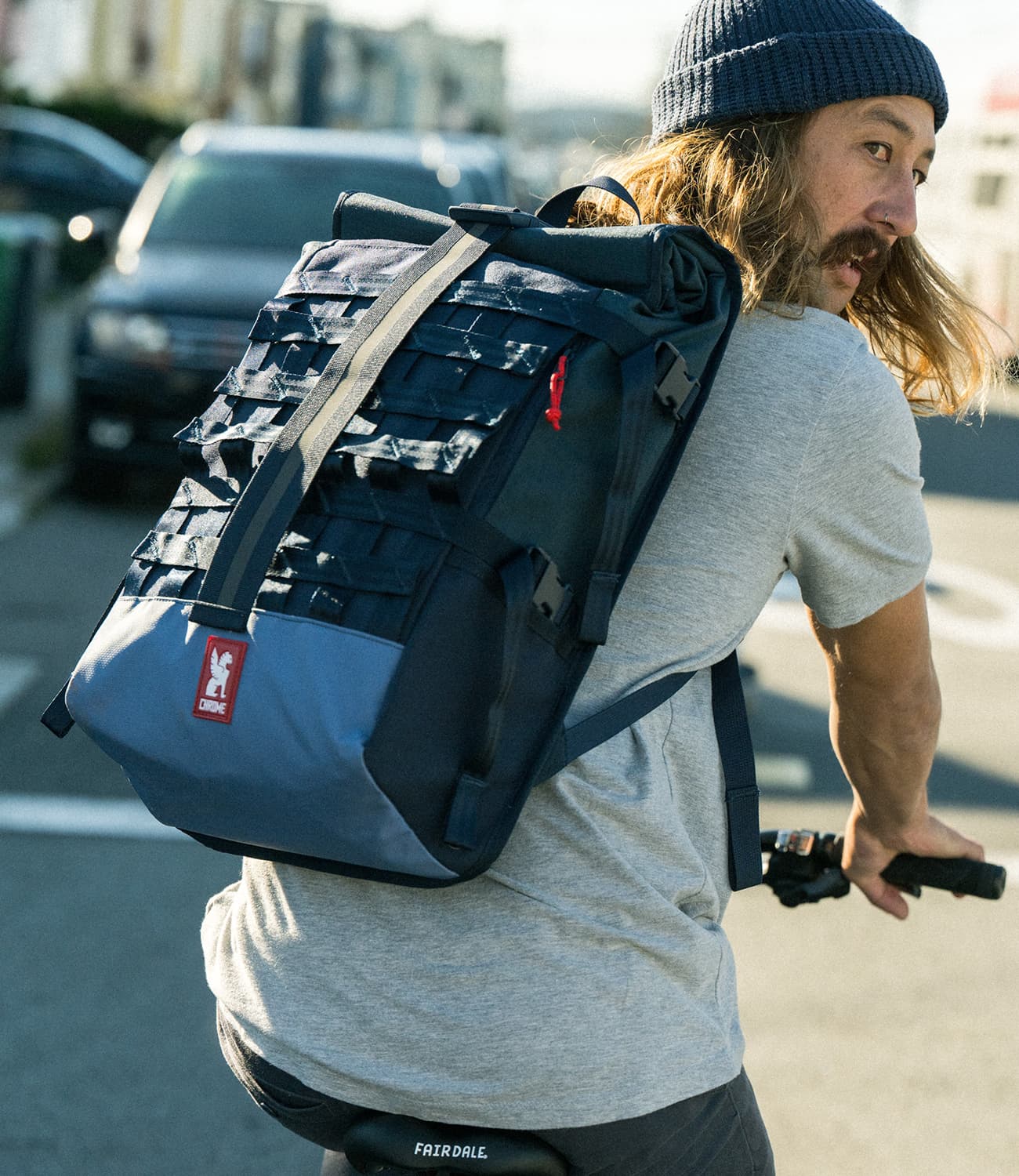Barrage Cargo Backpack in blue worn by a person cycling