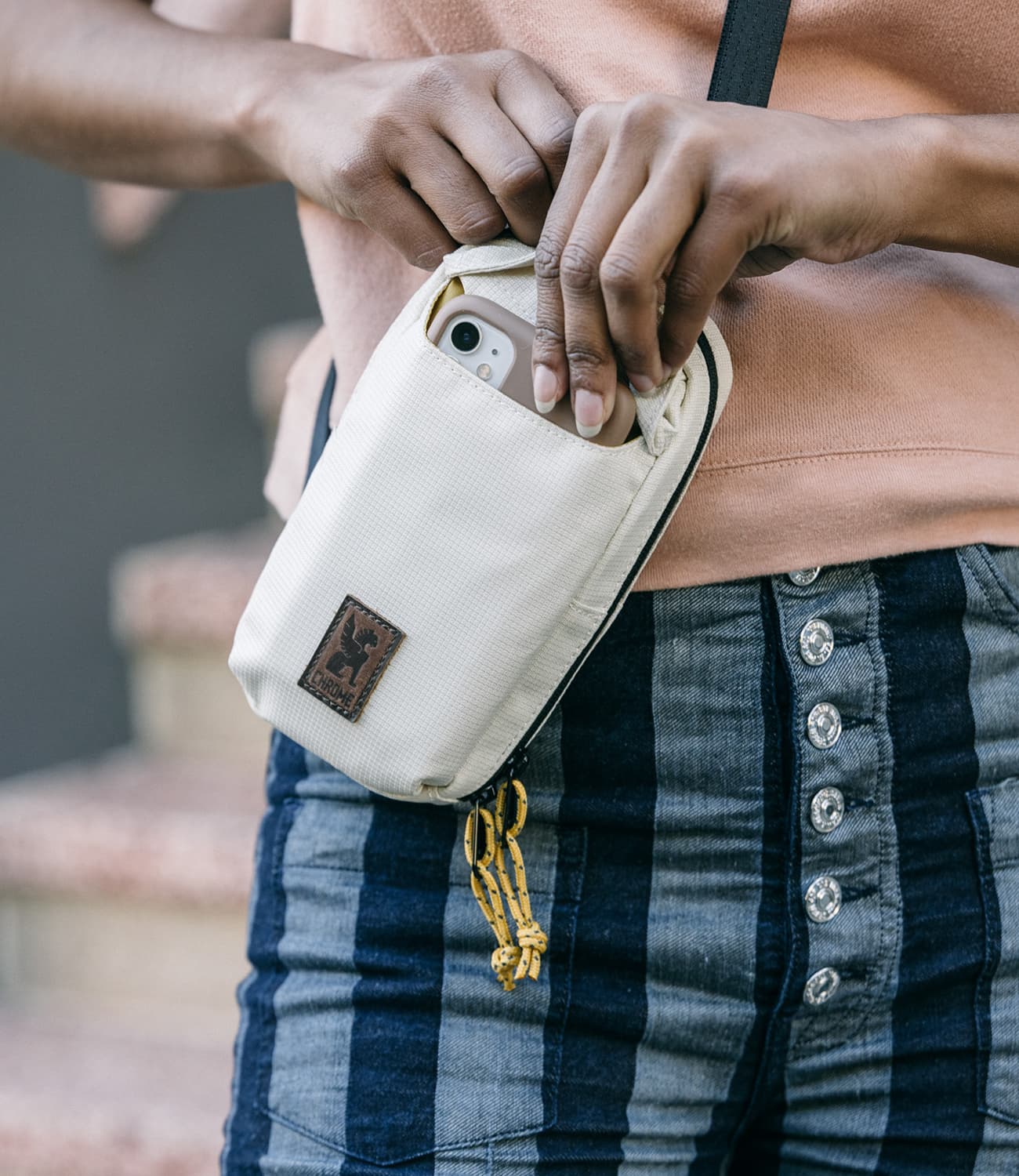 Ruckas Accessory pouch shown on a person stowing their phone